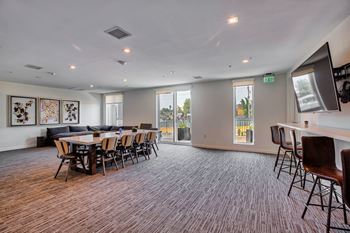A conference room with a long table and chairs.